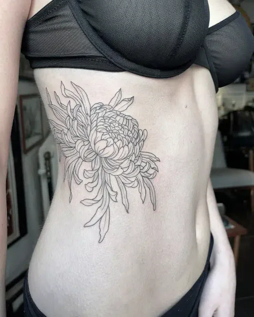 Fine line chrysanthemum tattoo on a ribcage