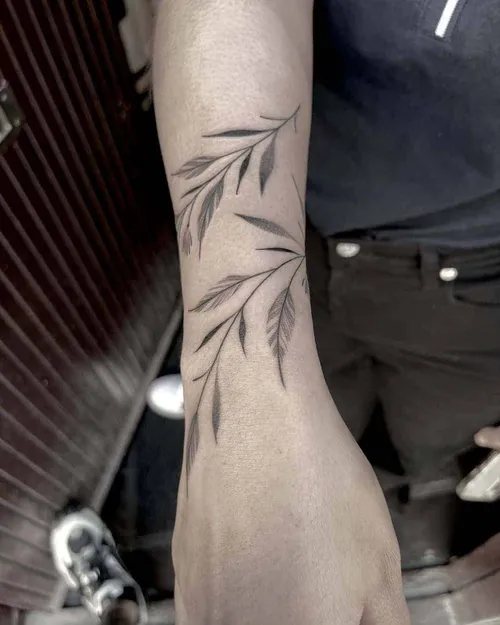 Fine line tattoo of leaves