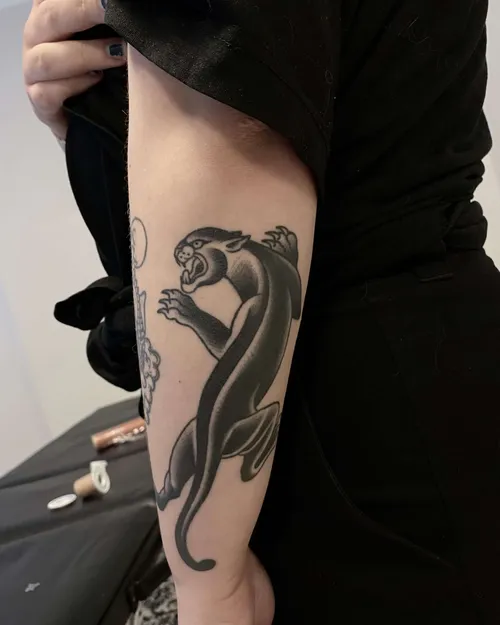 Traditional tattoo of a panther on a forearm