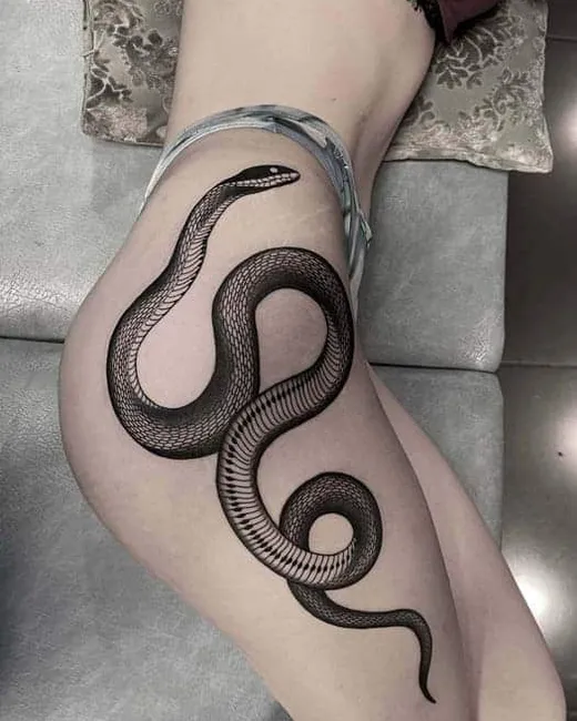 Blackwork-tatuering av en orm på en underarm