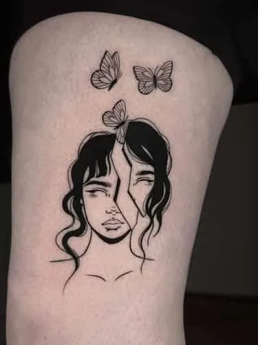 Blackwork-tatuering av ett kluvet ansikte
